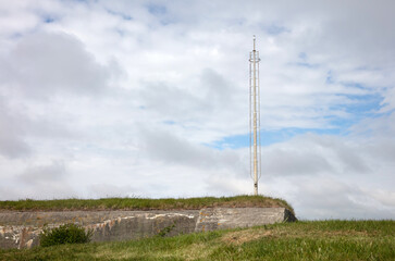 Fototapeta na wymiar Old communication or radar tower on top of a ww2 bunker