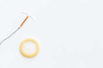 T-shaped intrauterine birth control device with condoms. Contraception concept