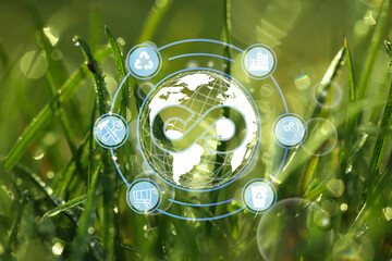 Circular economy concept. Green grass with dew and illustration of infinity symbol and different...