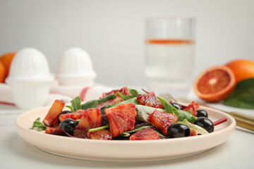 Delicious salad with sicilian orange on white table, closeup