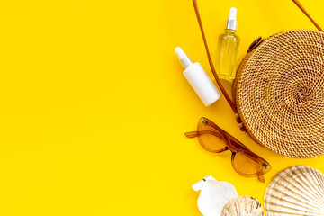 Summer rattan bag with beach accessories. Beach flatlay background