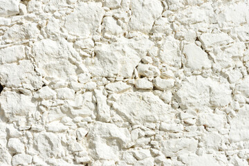 White plaster wall texture with crack background. Pattern of white plaster wall in rough aged structure