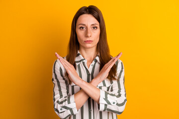 Photo of young woman crossed hands avoid ban block enough forbidden isolated over yellow color...