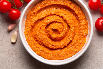 Salsa Romesco. Tomato-based Spanish vegetable sauce. Made from mixture of roasted tomatoes, roasted red bell peppers and garlic, toasted almonds, olive oil and bread. Close-up. - obrazy, fototapety, plakaty