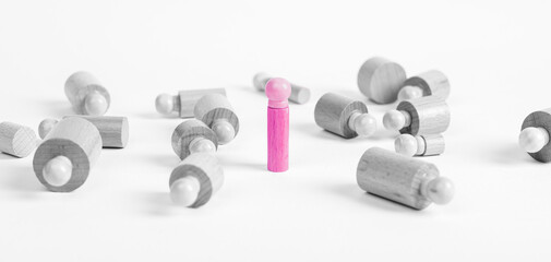 Standing outstanding pink Montessori cylinder like winner, survivor among lying ones. Wooden childish game. Overcoming obstacles due to uniqueness, individuality. High quality photo