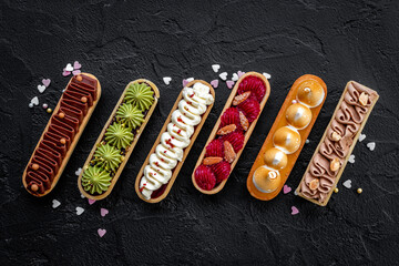 Sweet bakery eclairs with creamy decor, top view