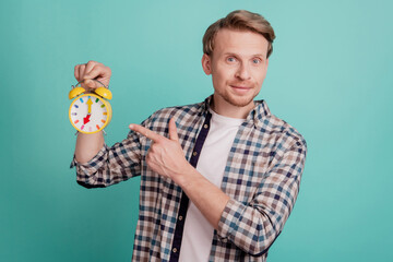 Promoter guy hold alarm clock direct finger alarm clock watch advice punctuality regime tips