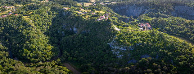 Panoramic aerial view of site Skocjanske Jame (Skocjan caves) with village Skocjan and deep gorge of Reka river, Slovenia
