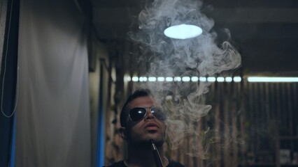 Arabic jordanian young man smokes a hookah.