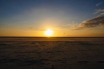 Fototapeta na wymiar Sunset on beach with scenic sky in horizon over water