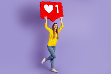Full body photo of young cheerful woman hold paper pinata click user ads choice isolated over purple color background