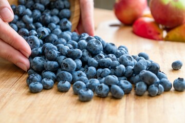 Food healthy blueberry berry organic. nature sweet. A woman sprinkles blueberries with her hands.