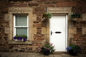 Fototapeta na wymiar Stone cottage door and window detail.