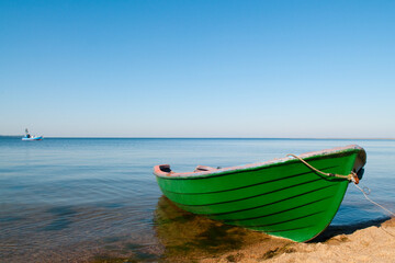 Landscape with green boat and sea