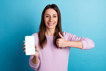 Fototapeta premium Photo of young lady present show thumb-up feedback suggest mobile device web nomad isolated over blue color background