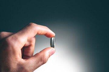 closeup man hand holding pills