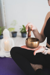 Portrait of a female yogi with a singing bowl