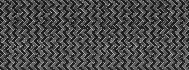 Abstract black gray seamless modern mosaic porcelain stoneware cement subway tile, patchwork laid in a herringbone pattern texture background banner panorama