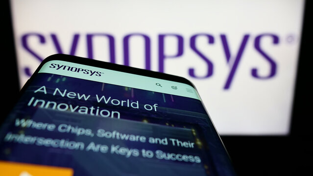 Stuttgart, Germany - 05-22-2022: Smartphone with website of US technology company Synopsys Inc. on screen in front of business logo. Focus on top-left of phone display.