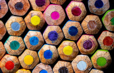 Fototapeta na wymiar Background of colorful colored pencils. Multicolored wooden pencils close up. Stationery set for drawing, coloring. Art school, a tool for creativity.