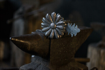 a flower with petals and a stamen, made of metal