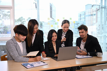 Successful business team brainstorming and discussing ideas for new project together at corporate office