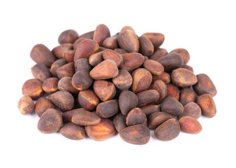 Pine nuts isolated on white background. Heap of raw pine nuts in shells