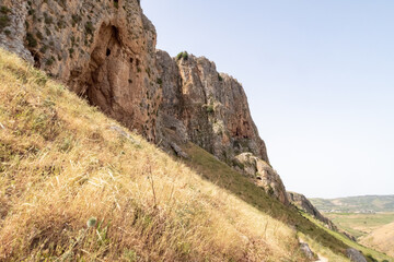 Overgrown  with small crooked trees, grass and bushes, the slope of Mount Arbel, located on the shores of Lake Kinneret - the Sea of Galilee, near the city of Tiberias, in northern Israel.