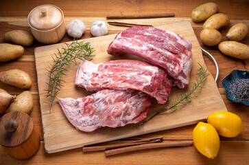 Raw Pork ribs with with a rosemary on wooden plate, Pork Spare Ribs on wooden table.
