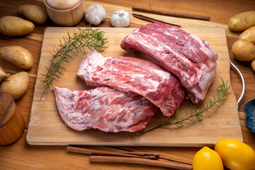 Raw Pork ribs with with a rosemary on wooden plate, Pork Spare Ribs on wooden table.