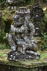 Fototapeta na wymiar Monkey God Statue on Mossy Buddhist Altar Portrait, Gunung Kawi Temple, Bali
