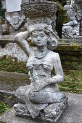 Fototapeta na wymiar Female Kneeling Stone Statue Portrait, Bali