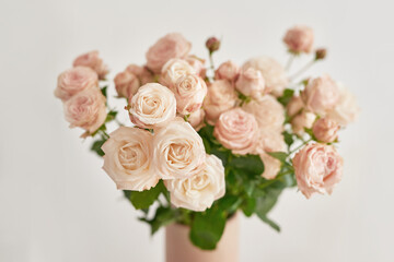 Good cozy morning. Bouquet of rose flowers in vase on table. Hotel room with bed. Check in hotel. Rest and relaxation. Coffee in bed. Romantic breakfast. Valentine's Day