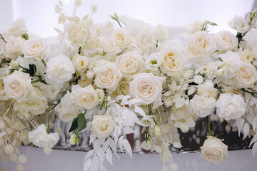 Wedding bouquet in restaurant on the table. White flowers .Element of decor in restaurant. Decoration on wedding. Beautiful and elegant