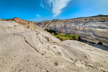Famous white rocks of Sarakiniko beach, Aegean sea, Milos island , Greece. No people, empty cliffs, summer sunshine, blue sky and clouds