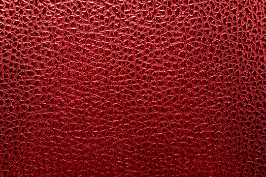 Texture of red leather close-up top view