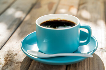 blue ceramic coffee cup on the old wooden floor.