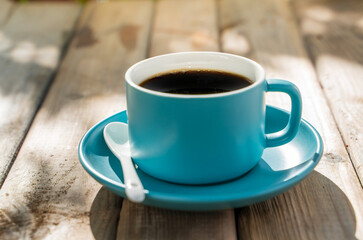 blue ceramic coffee cup on the old wooden floor.
