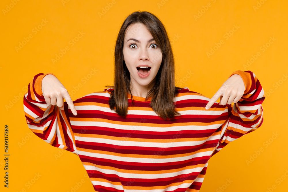 Wall mural young happy surprised amazed fun woman 20s wear red striped sweatshirt point index finger down on wo