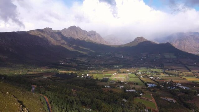 Scenic road of Franschhoek pass overlooking lush wine valley and farms