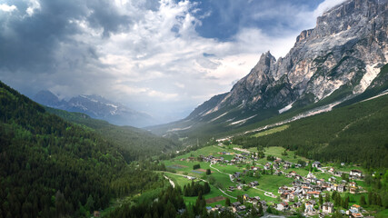 Fototapeta na wymiar Beautiful mountain landscape with green fields and mountains in the background. Dolomites mountains. 