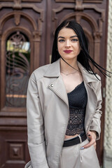 Beautiful young woman wear fashion white suit  against old wooden door