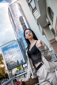 portrait of fashion woman against city center high-rises