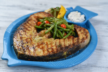 fish steak with asparagus, salmon steak with vegetables, tomatoes, asparagus