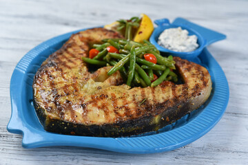 fish steak with asparagus, salmon steak with vegetables, tomatoes, asparagus