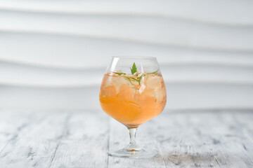 citrus tropical cocktail in wine glass with mint