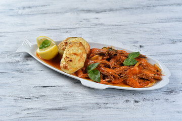 shrimp with tomato sauce and baked potatoes