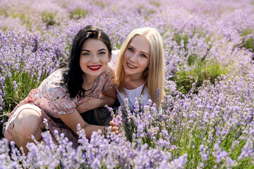 two girlfriends have  good time on a lavender field