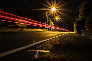 Fototapeta na wymiar Landstraße mit Lichtspuren von Fahrzeugen.
