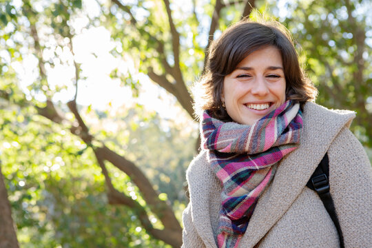 portrait of a normal woman in a park smilig